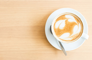 Hot art Latte Coffee in a cup on wooden table