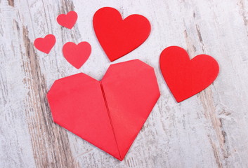 Valentine red hearts on old wooden white table, symbol of love