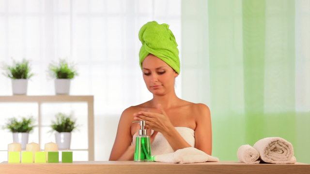Woman and man wearing towels applies beauty treatment
