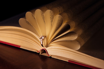 Wedding ring with briliant on the book pages