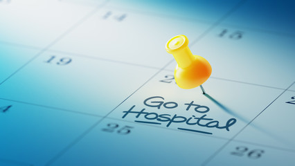 Concept image of a Calendar with a yellow push pin. Closeup shot