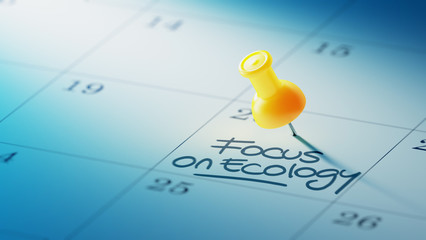 Concept image of a Calendar with a yellow push pin. Closeup shot