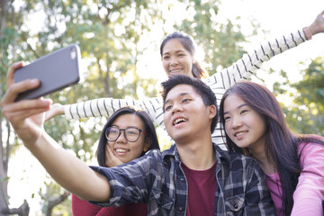 Obraz premium Group of Friends taking Self Portraits with Mobile Phone