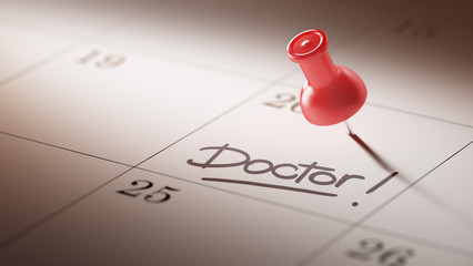 Concept image of a Calendar with a red push pin. Closeup shot of