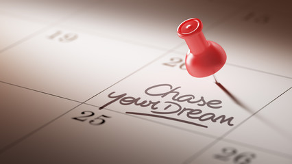 Concept image of a Calendar with a red push pin. Closeup shot of
