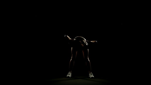 Woman is warming up  slow motion isolated on black  