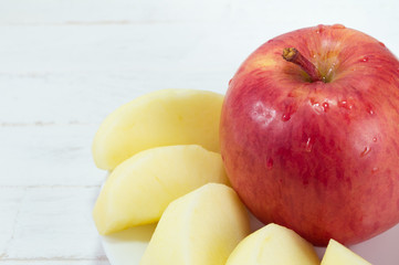 Red apples on white wood background