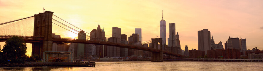 Manhattan skyline panorama with Brooklyn Bridge at sunset, New York, United States