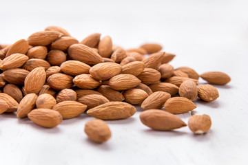 almonds in heap isolated on white background