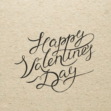 Happy Valentines day card. Calligraphy lettering on cardboard.