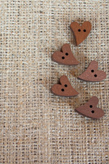 Wooden buttons hearts on sackcloth with space for text