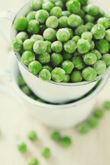 frozem peas on wooden surface