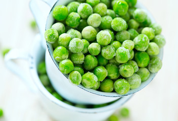 frozem peas on wooden surface
