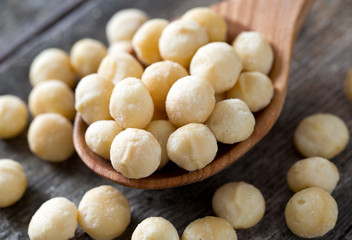 salted macadamia nuts on wooden surface