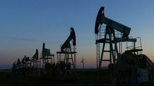 many working oil pumps silhouette in dusk, 4k
