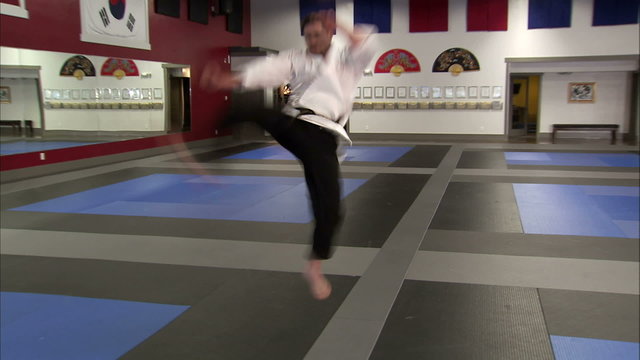Man showing punches and kicks at a karate studio.