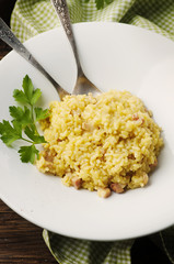 Italian traditional risotto with saffron and ham