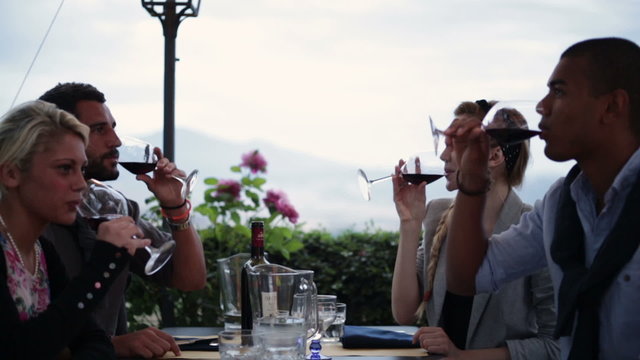 Friends at italian restaurant in the evening make a toast