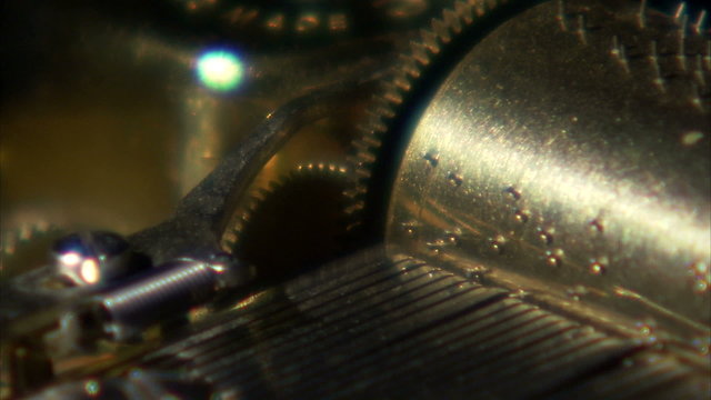 Extreme close up of music box gears turning.