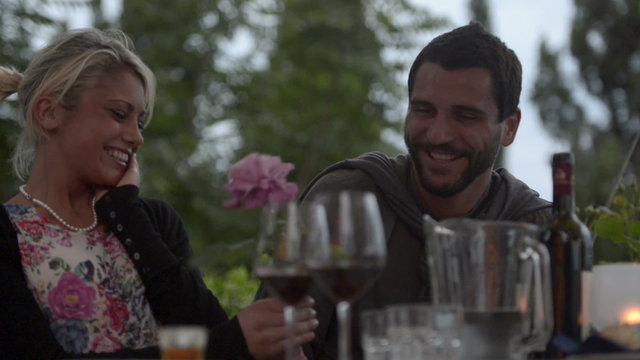 Man at italian restaurant present a rose to a woman