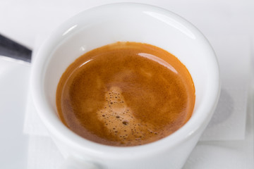 Closeup of espresso cup with coffee.