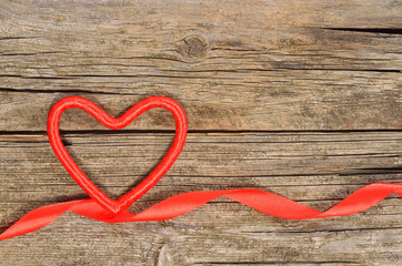 Decorative heart and ribbon on wooden table. Top view, copy space. Valentines day concept