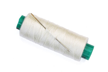 needle and a spool of thread