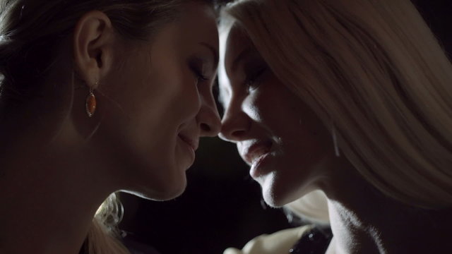 Close up lesbian couple smile and romantic kiss slow motion  