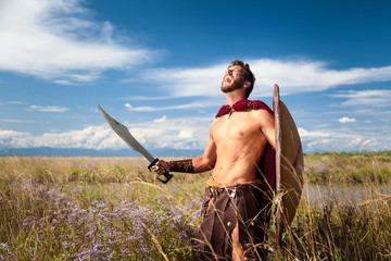 Fighting ancient warrior in landscape background