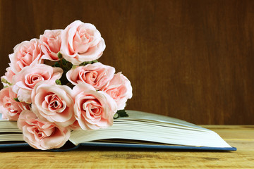 Rose flowers on open book vintage style.