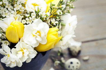 Bouquet of yellow tulips on wooden background, selective focus