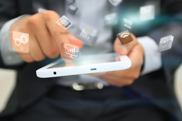 Businessman touching business icon on tablet.
