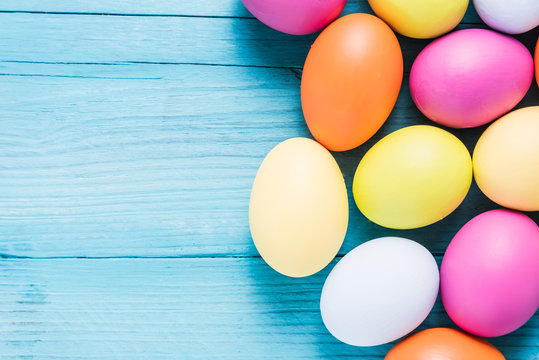 Easter eggs in pastel colors on wooden table