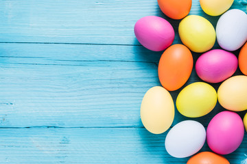 Easter eggs in pastel colors on wooden table