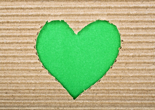 Green heart cut from corrugated cardboard