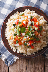 Asian Couscous with vegetables close-up. vertical top view
