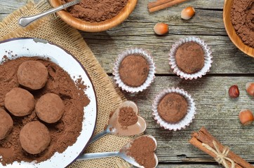 Dark chocolate truffles with cocoa powder, biscuit and chopped hazelnuts for loved. Valentines day concept. Top view. 