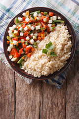 Couscous with vegetables and herbs. vertical top view
