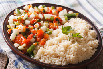 Tasty couscous with vegetable salad close-up on a plate. horizontal

