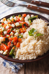 Vegan couscous with vegetable on a plate closeup. Vertical
