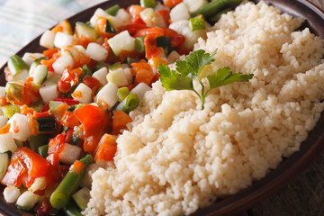 Vegetarian food couscous with vegetable salad on a plate. horizontal
