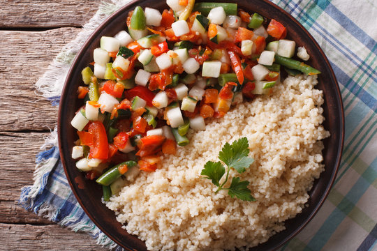 Couscous with vegetables and herbs closeup. Horizontal top view
