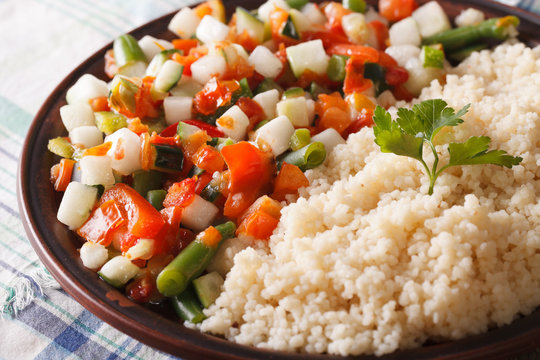 couscous with vegetable salad on a plate macro. horizontal
