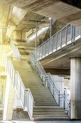 Fototapeta premium Marble stairs under the bridge with oragne sun