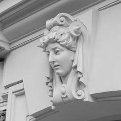 decorative statue of a woman on facade