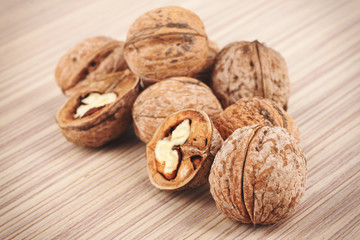 Group of cracked walnuts on wooden background