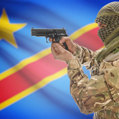 Male with gun in hands and national flag on background - Congo-Kinshasa