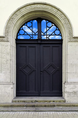 Old vintage building door with sky reflection