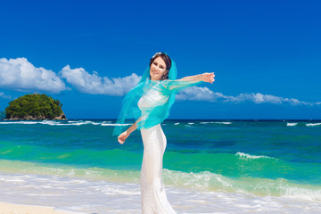 Fototapeta na wymiar Beautiful brunette bride in white wedding dress with turquoise v