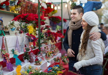 Couple buying Christmas flower at market